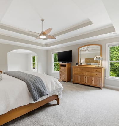 Spacious master bedroom featuring natural light, a cozy atmosphere, and modern amenities for ultimate relaxation.