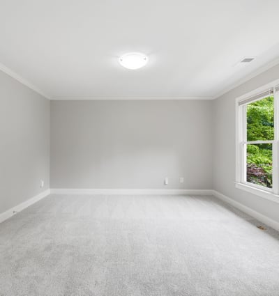 Spacious room with large windows offering natural light, perfect for customization and personal touches.