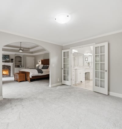 Spacious master suite featuring a cozy ambiance, private bathroom, and direct access to a serene living area.