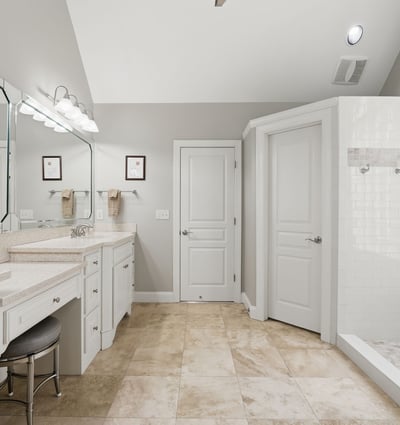 Spacious bathroom featuring dual vanities, modern fixtures, and a large walk-in shower for ultimate convenience.