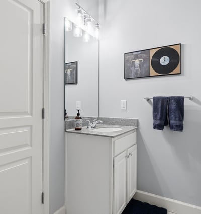 Bright and functional bathroom featuring modern fixtures, a spacious countertop, and contemporary decor.