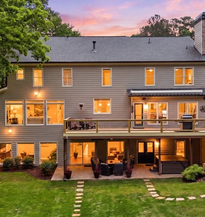 Spacious home with large windows and a welcoming deck, perfect for entertaining and enjoying outdoor views.