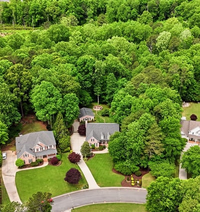Discover a landscaped community nestled among lush greenery, offering privacy and a peaceful suburban lifestyle.