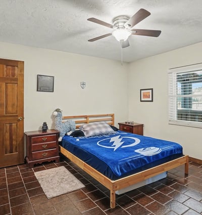 First bedroom, located off of the foyer, with has two doors to access it. One door is across from the guest bathroom for easy accessibility, while the other door is off of the foyer.