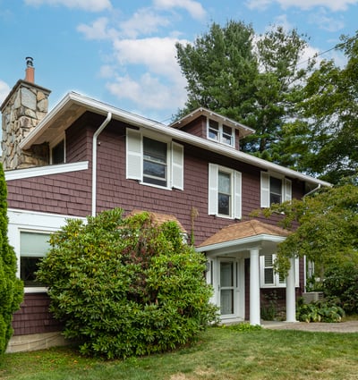 Spacious home featuring unique architectural details and ample greenery, perfect for outdoor gatherings and relaxation.