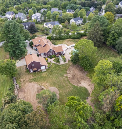 Spacious property with a large backyard, pool, and surrounding greenery, perfect for recreation and relaxation.