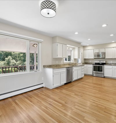 Spacious kitchen with modern appliances and ample natural light, perfect for culinary enthusiasts and gatherings.