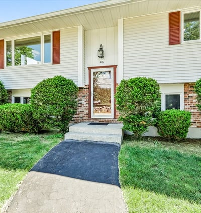 This well-maintained split-level home features inviting landscaping and a welcoming entrance. Perfect for family living.