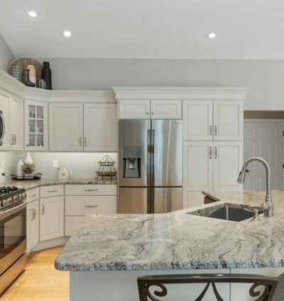 Modern kitchen with sleek granite countertops, stainless steel appliances, and ample cabinetry for convenient storage.
