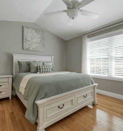 Bright and inviting bedroom featuring a cozy bed, modern furnishings, and abundant natural light.