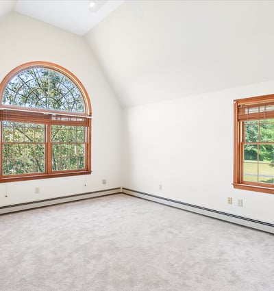 Bright and airy bedroom featuring large windows that invite abundant natural light and picturesque views.