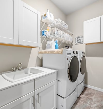 Laundry room off of the entry and walks through to primary suite.