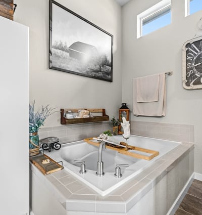 Primary Suite with attached 5 piece bath and walk in closet.