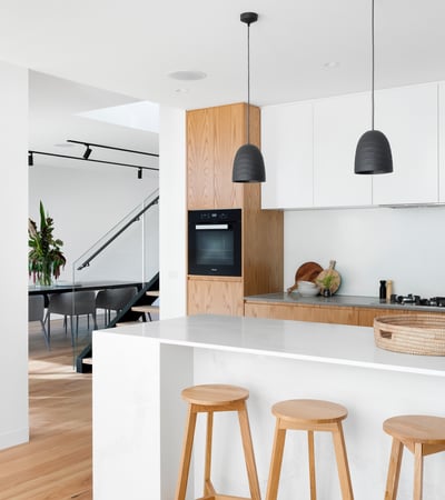 Modern kitchen featuring sleek finishes, stylish pendant lighting, and a spacious island, perfect for entertaining.