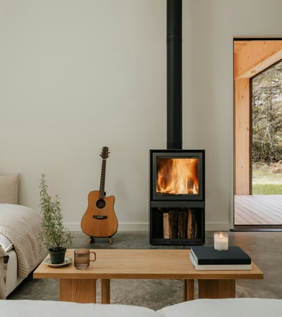 Cozy retreat featuring a warm fireplace, inviting seating, and seamless indoor-outdoor connection.