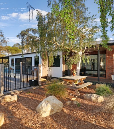 Discover this modern home featuring an inviting outdoor space, pool, and beautiful landscaping for relaxed living.