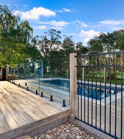 Discover a modern outdoor retreat featuring a pristine pool and expansive nature views, perfect for relaxation.