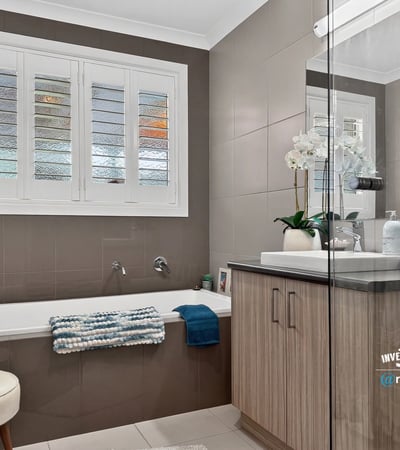 Modern bathroom featuring a spacious tub, ample natural light, and contemporary fixtures for everyday comfort.