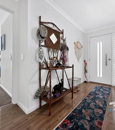 Bright and inviting entrance features unique decor, leading to spacious living areas filled with natural light.