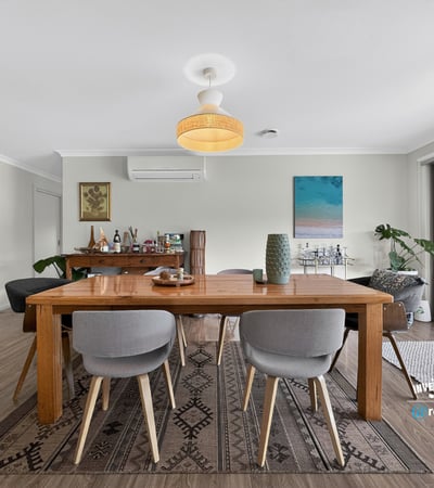 Bright and inviting dining area with modern furnishings, seamlessly connecting to an outdoor entertaining space.
