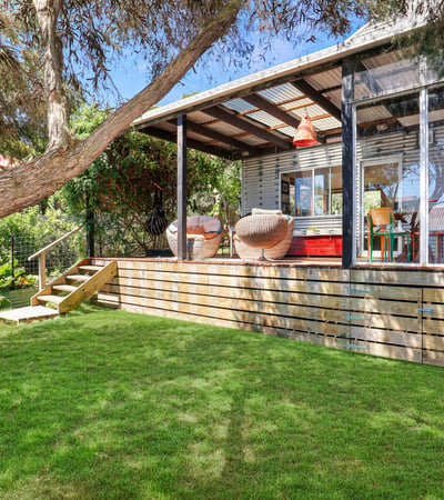 Bright and inviting outdoor space featuring a spacious deck, ideal for relaxation and entertaining.