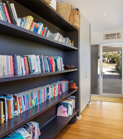 Bright hallway featuring built-in bookshelves, perfect for displaying your favorite reads and personal touches.