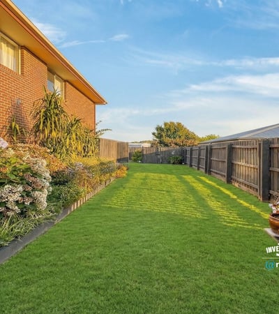 Spacious backyard oasis featuring lush greenery, perfect for outdoor gatherings and private relaxation.