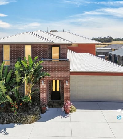 Modern home featuring a spacious layout, landscaped front yard, and ample natural light throughout.