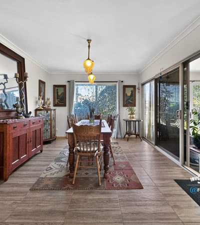 Spacious dining area featuring natural light, attractive décor, and easy access to a vibrant outdoor space.