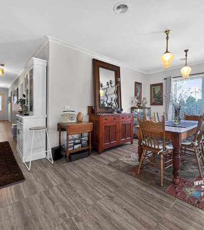 Spacious dining area featuring natural light and direct access to a beautifully landscaped outdoor space.