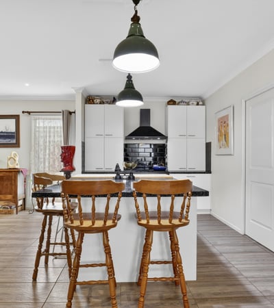 Modern kitchen with ample storage, featuring a central island and inviting dining area for casual meals.