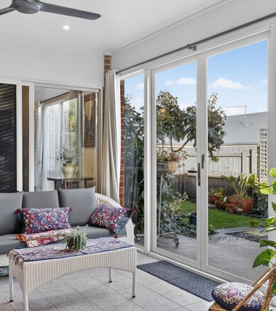 Bright and airy sunroom featuring large windows, perfect for relaxation and enjoying views of the garden.