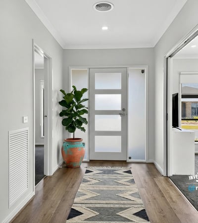 Bright entryway featuring contemporary design elements and welcoming greenery, perfect for creating lasting first impressions.