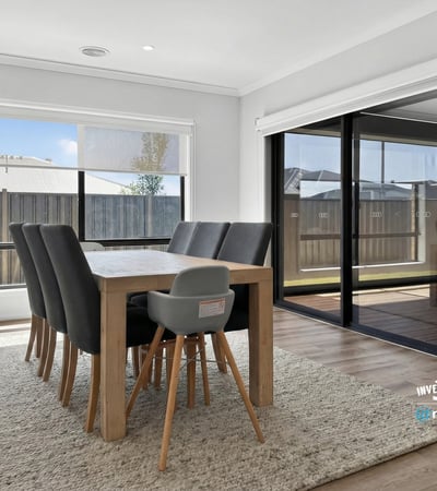 Spacious dining area features large windows and seamless indoor-outdoor flow, perfect for entertaining.