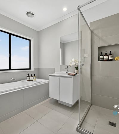 Modern bathroom featuring a glass shower, soaking tub, and sleek cabinetry for a contemporary finish.
