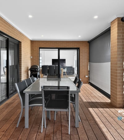 Spacious outdoor dining area with modern finishes, perfect for entertaining or relaxing in comfort.
