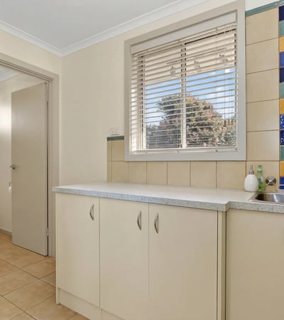 Bright and functional kitchen space featuring colorful backsplash tiles and ample storage options.
