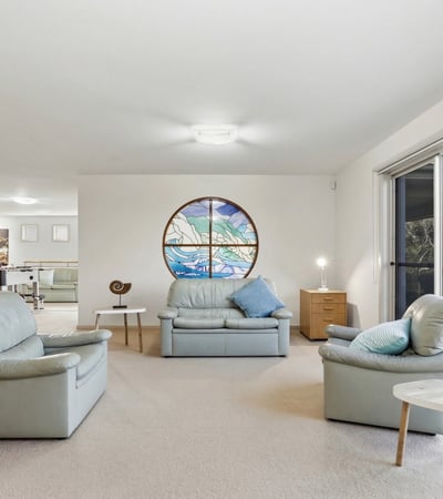 Spacious living area featuring large windows and scenic views, perfect for relaxation and entertaining.