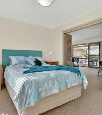 Bright and inviting bedroom with ample natural light and direct access to a spacious balcony.