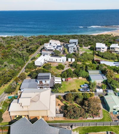 Stunning coastal property with expansive ocean views, surrounded by lush greenery and spacious outdoor areas.