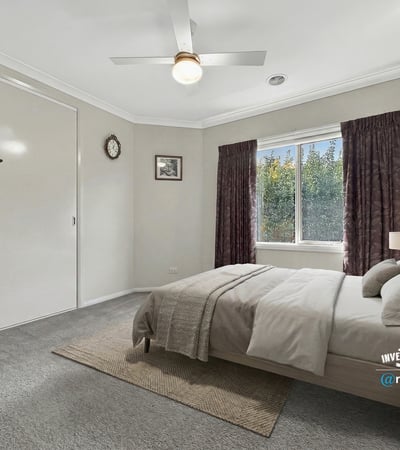 Bright bedroom featuring a cozy layout, large window, and ample storage for a comfortable living experience.
