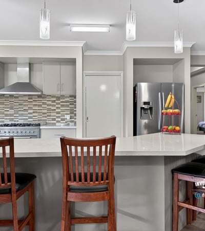 Modern kitchen featuring sleek appliances, a spacious island, and ample natural light for cooking and entertaining.