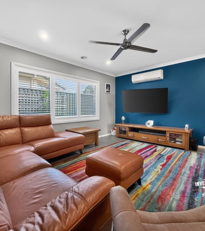 Spacious living area featuring modern furnishings, vibrant colors, and ample natural light for comfortable gatherings.