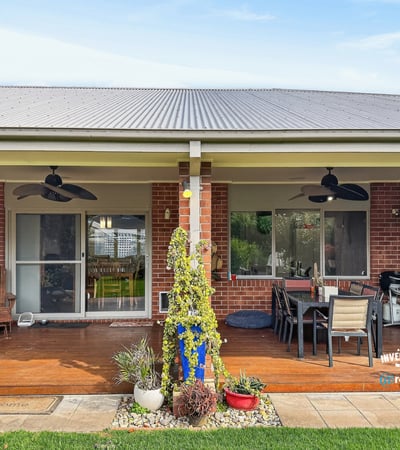 Spacious outdoor area with a covered patio, perfect for entertaining and enjoying the serene backyard.