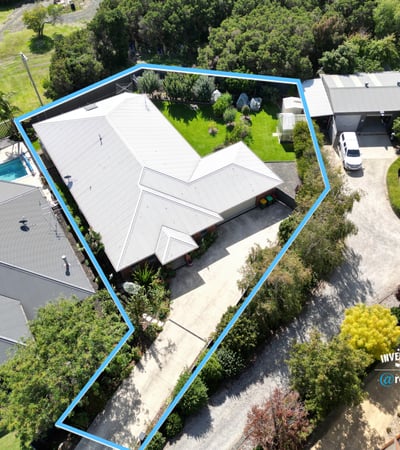 Spacious property featuring a lush yard, pool, and ample parking with a functional layout.