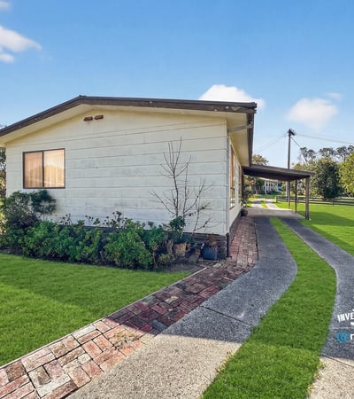Modern home featuring a spacious yard and inviting pathway, perfect for outdoor entertaining and relaxation.