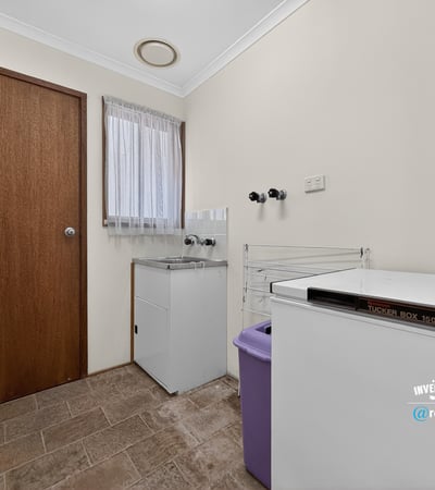 Functional laundry space featuring ample storage and convenient layout for efficient household management.