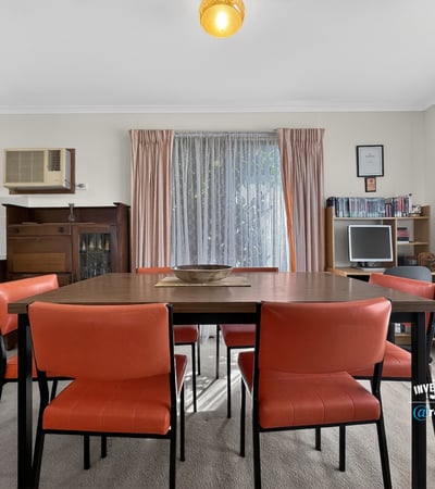 Bright dining area featuring a spacious table and large windows that invite natural light.