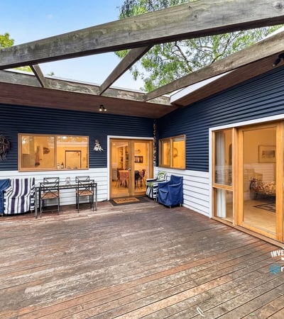 Spacious outdoor deck seamlessly connects to a cozy interior, perfect for entertaining and relaxation.