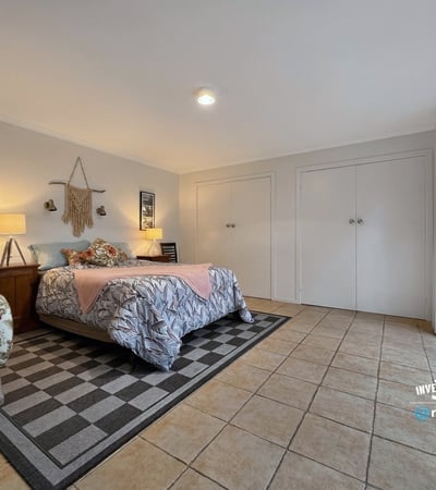 Spacious bedroom featuring ample storage, natural light, and direct access to the outdoor patio.